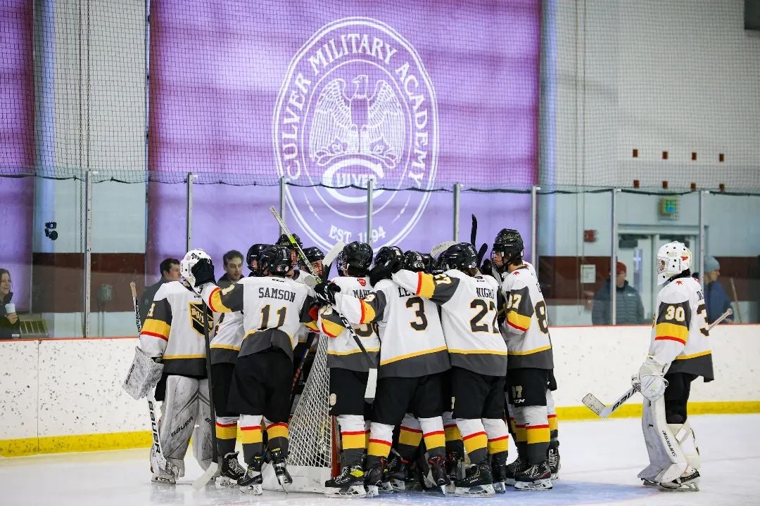 Hockey players celebrating a win at the ice rink